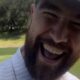 Travis Kelce plays air guitar to Taylor Swift's 'Bad Blood' on the golf course as friends blast out her hit song to try and distract him - only for the Super Bowl winner to to hit an amazing shot: 'KillaTrav cannot be rattled!'